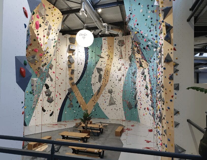 A room with many climbing walls and benches.